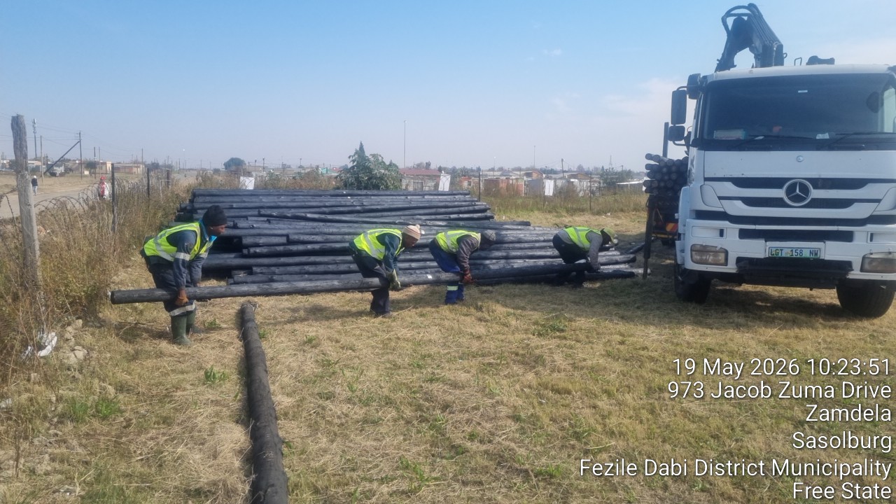 Material delivery truck and crane unloading poles