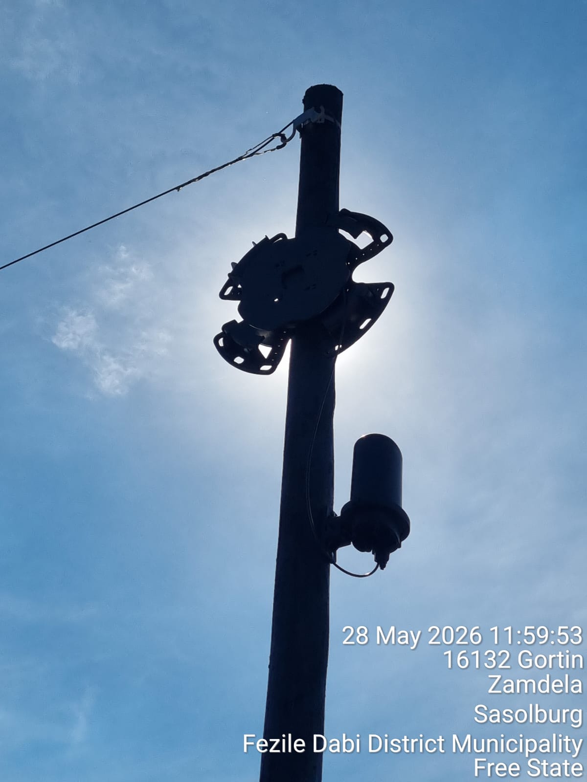 New wooden pole rising against cloudy sky